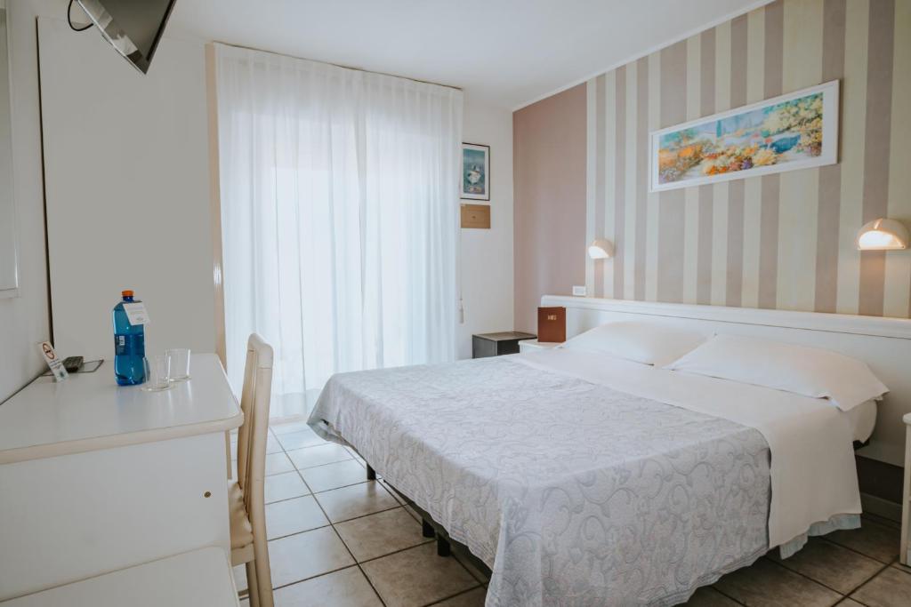 Postel nebo postele na pokoji v ubytování Hotel Gabriella