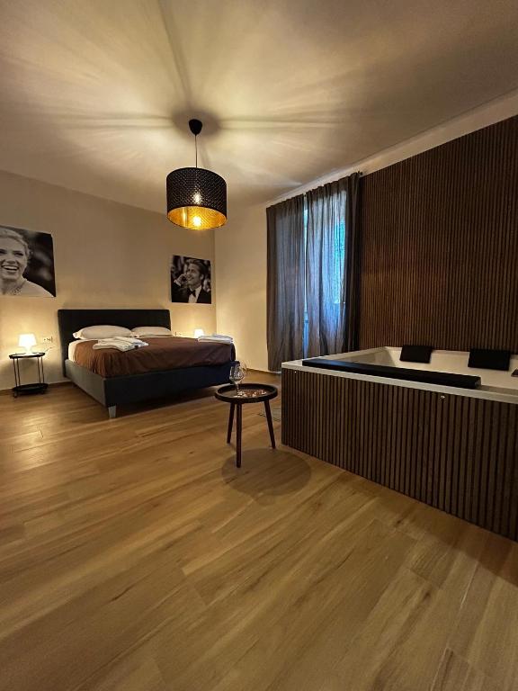 a bedroom with a bed and a tub in it at LA POLVERISTA Appartamento riservato e comodo in Bellizzi Irpino