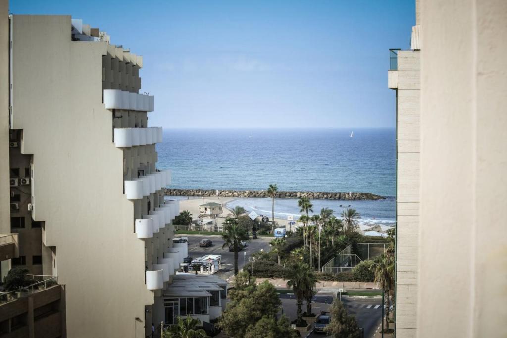 a view of the beach from a building at Skyline 1BR Apartment with City and Sea View Sea N' Rent in Herzliyya B