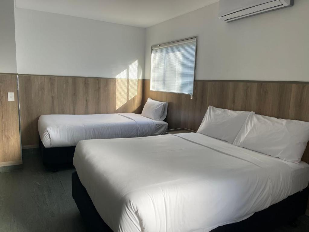 Postel nebo postele na pokoji v ubytování Conway Motel Manukau