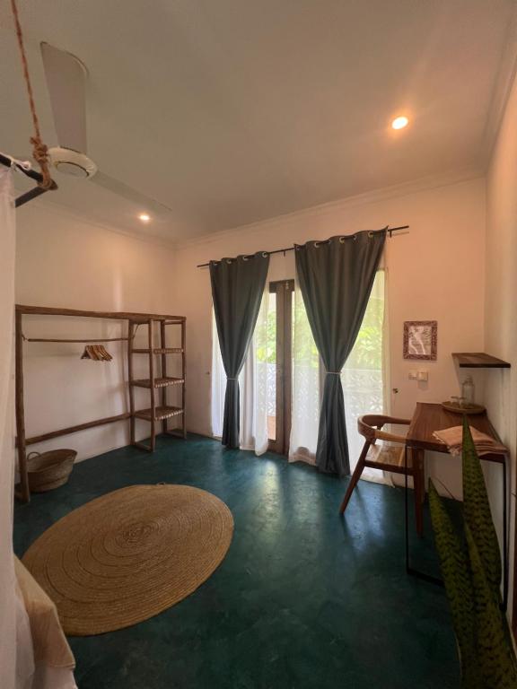 a living room with a table and a room with a table at Siri Beach Lodge in Nungwi