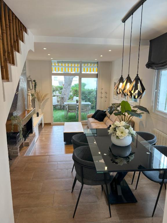 a living room with a table and some chairs at Casa Orquídea in Platja d'Aro