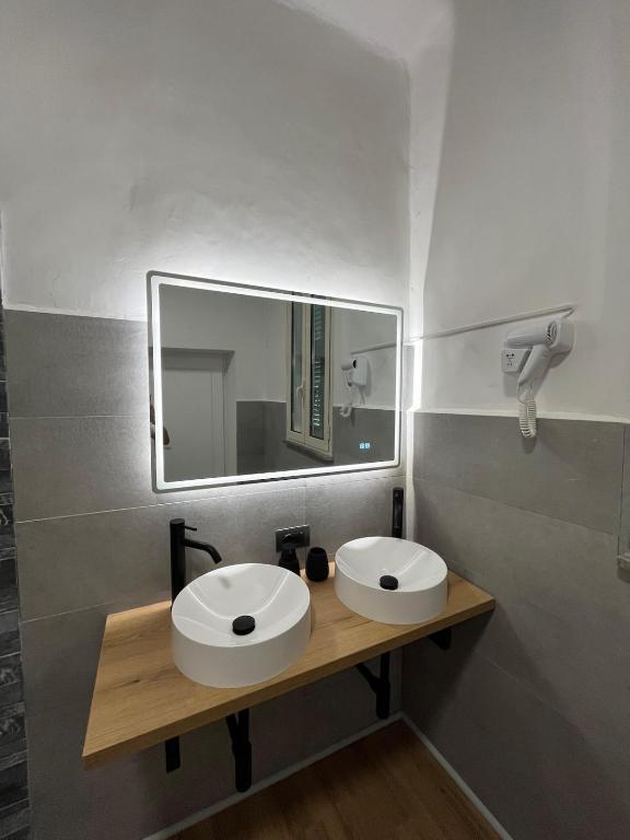 a bathroom with a white sink and a mirror at Nas's House in Ronciglione