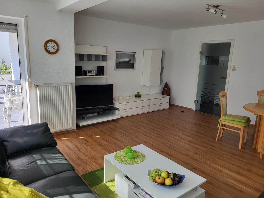 a living room with a couch and a table at Bodensee Idylle in Friedrichshafen