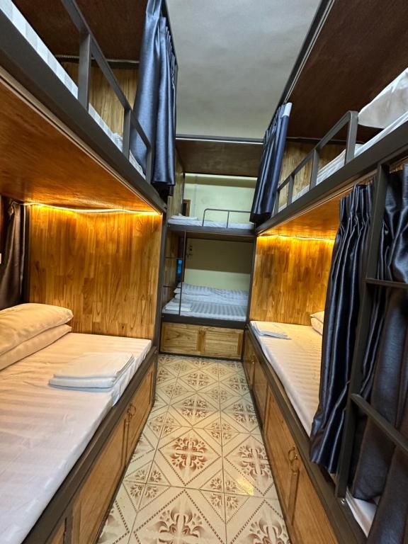 a room with two bunk beds and a floor at Bonsai Homestay in Sa Pa