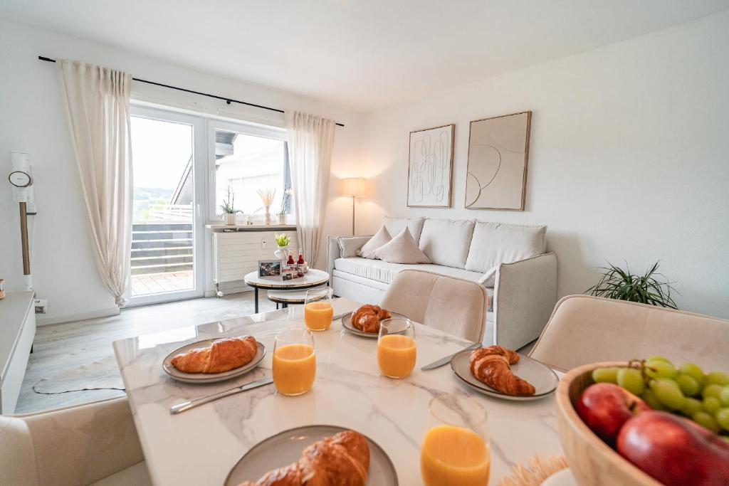 ein Wohnzimmer mit einem Tisch mit Essen drauf in der Unterkunft Gemütliche Ferienwohnung mit Berg und Alpsee Panorama im Allgäu in Immenstadt im Allgäu
