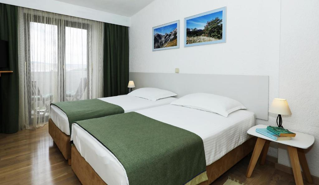 Postel nebo postele na pokoji v ubytování Hotel Rajna