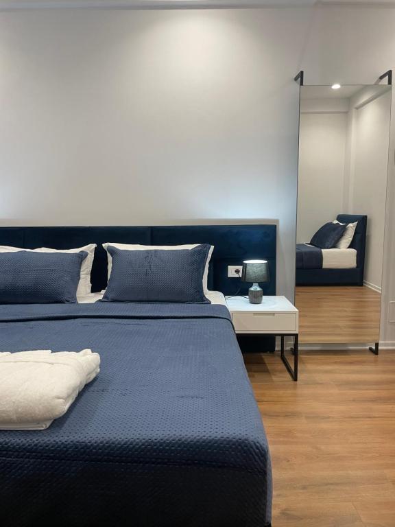 a bedroom with two beds and a couch at SEA & LAKE VIEW VILLA in (( Kalive Gjoka ))