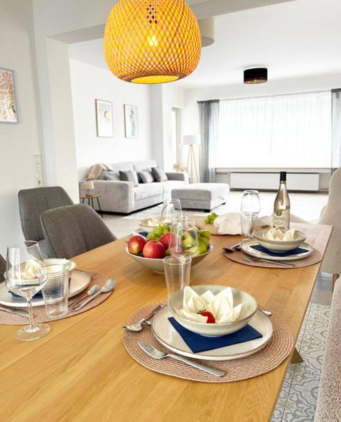 a dining room table with plates and bowls of fruit on it at Exklusive Wohnung mit Ahrblick 3 in Bad Neuenahr-Ahrweiler