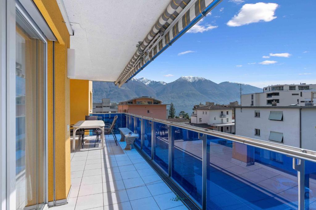 a balcony with a view of the mountains at Casa Verbanella - Objekt 7500 in Minusio