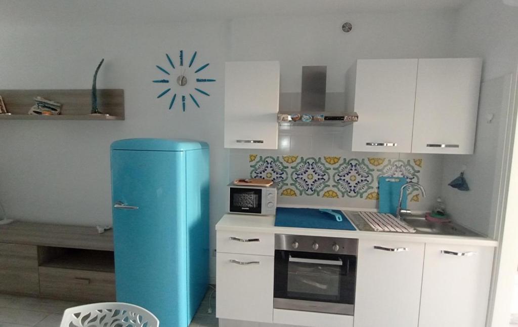 a kitchen with a blue refrigerator in a room at twins home in Castiglione della Pescaia