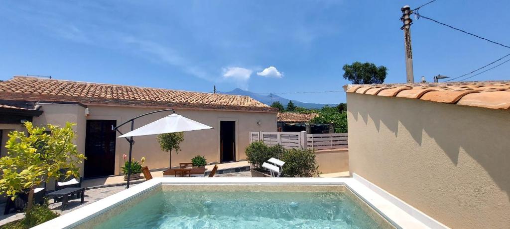 a swimming pool in front of a house at Casa Badia in Santa Venerina