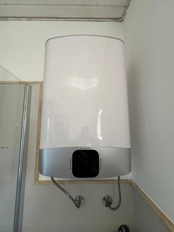 a white light on a wall in a bathroom at Villa SHU in Krimovice
