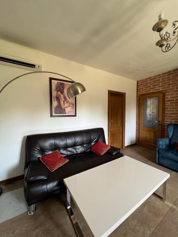 a living room with a couch and a table at Villa SHU in Krimovice