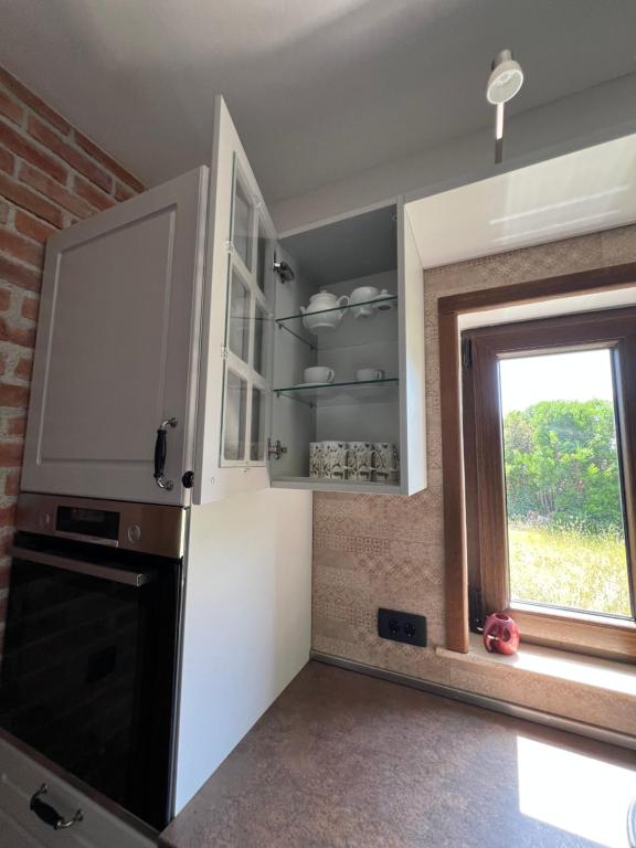 a kitchen with a tv and a window at Villa SHU in Krimovice