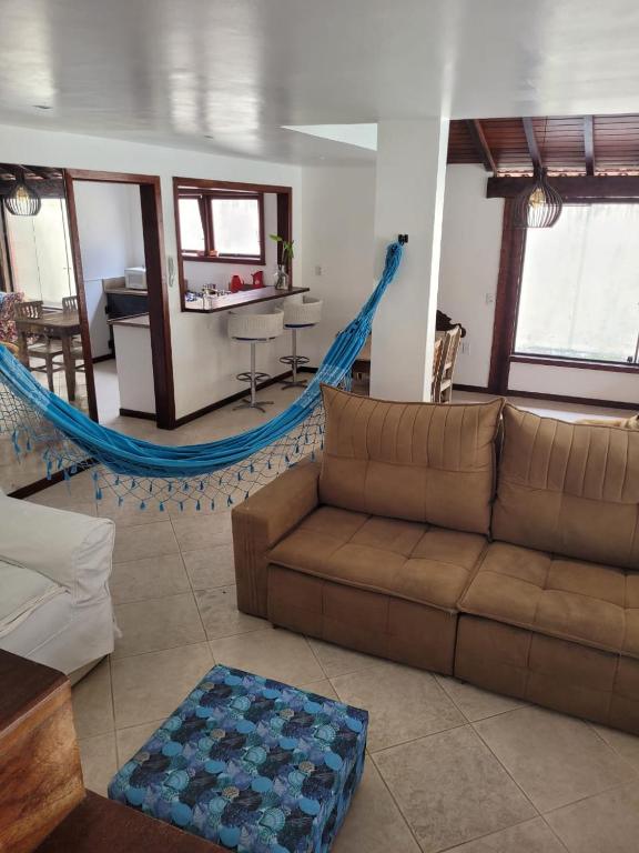 a living room with a couch and a hammock at CasaLegal in Búzios