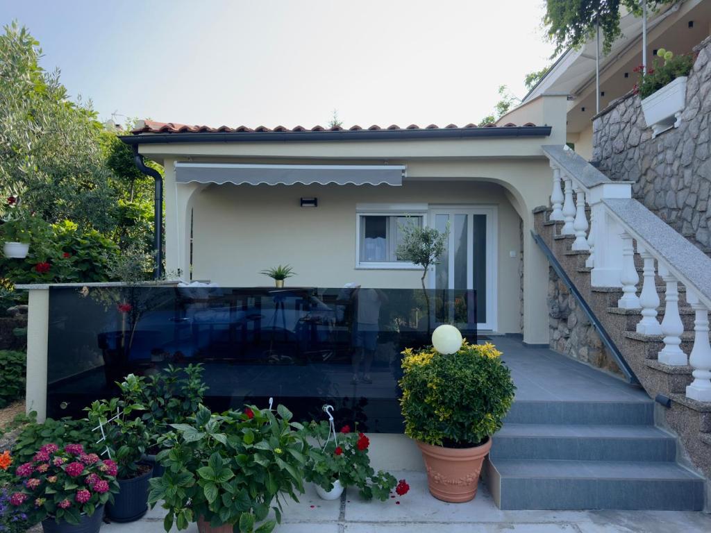 a house with some plants on the stairs at Apartman Meld in Vrh