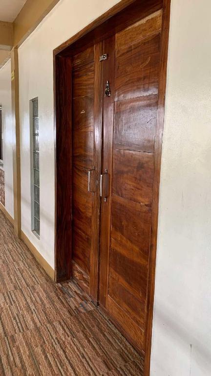 a wooden door in a hallway of a building at Cabongaoan Beach, Burgos, Pangasinan 