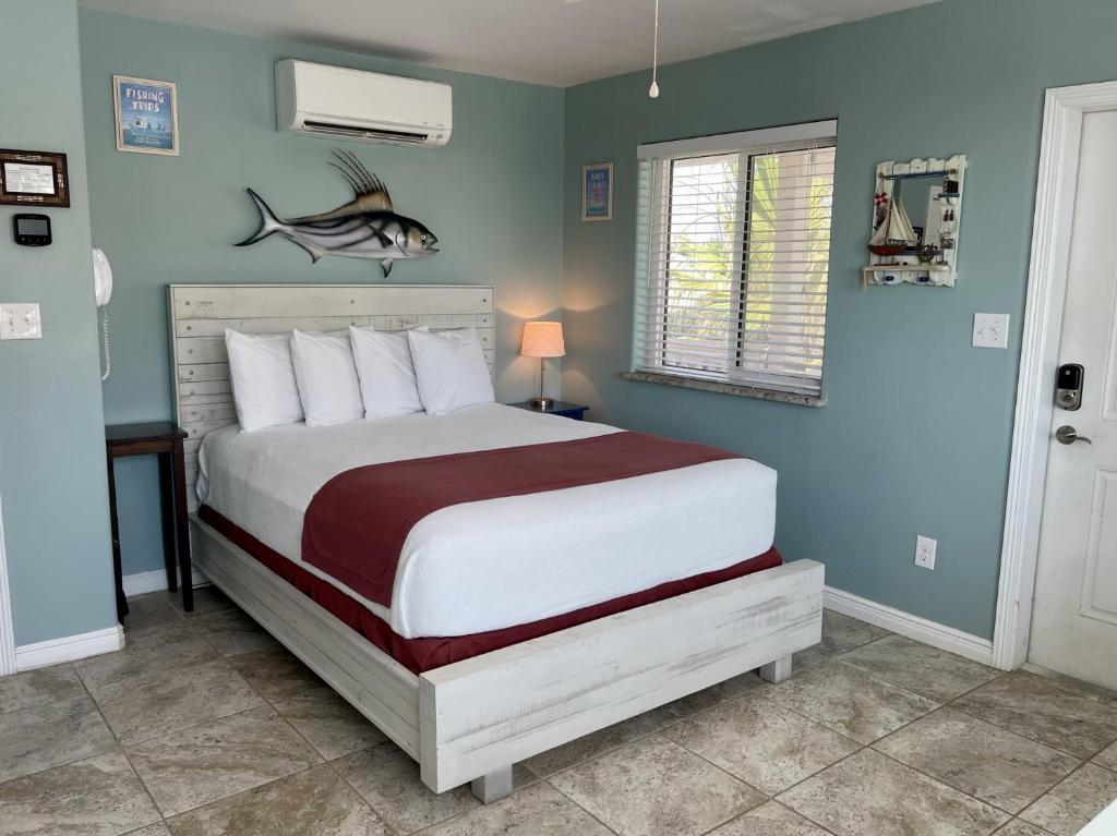 a bedroom with a bed with a fish on the wall at Beachgate Condo Suites and Hotel 232 condo in Port Aransas