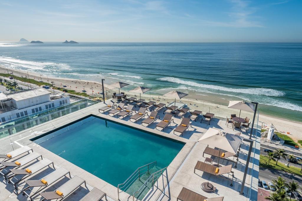 an overhead view of a swimming pool and the beach at Windsor Marapendi Hotel in Rio de Janeiro