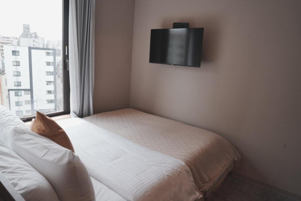 Postel nebo postele na pokoji v ubytování ICHIYU HOTEL ASAKUSA
