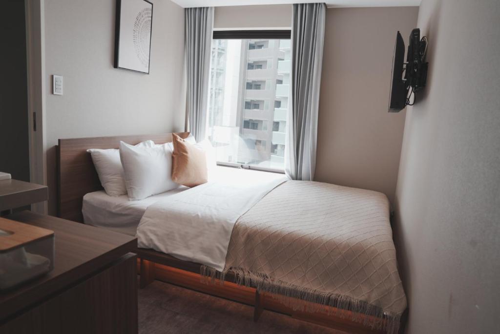 Postel nebo postele na pokoji v ubytování ICHIYU HOTEL ASAKUSA