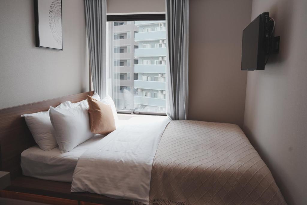 Postel nebo postele na pokoji v ubytování ICHIYU HOTEL ASAKUSA