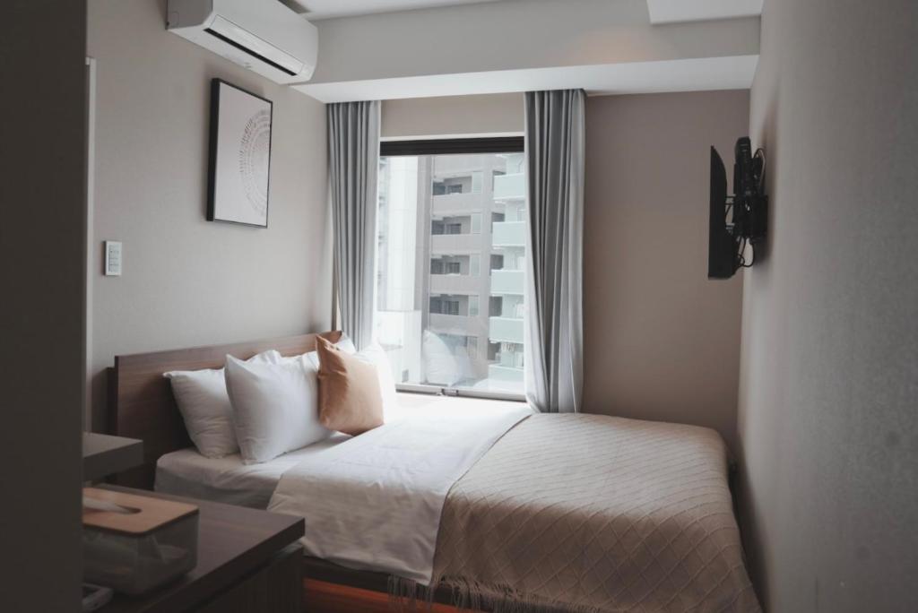 Postel nebo postele na pokoji v ubytování ICHIYU HOTEL ASAKUSA