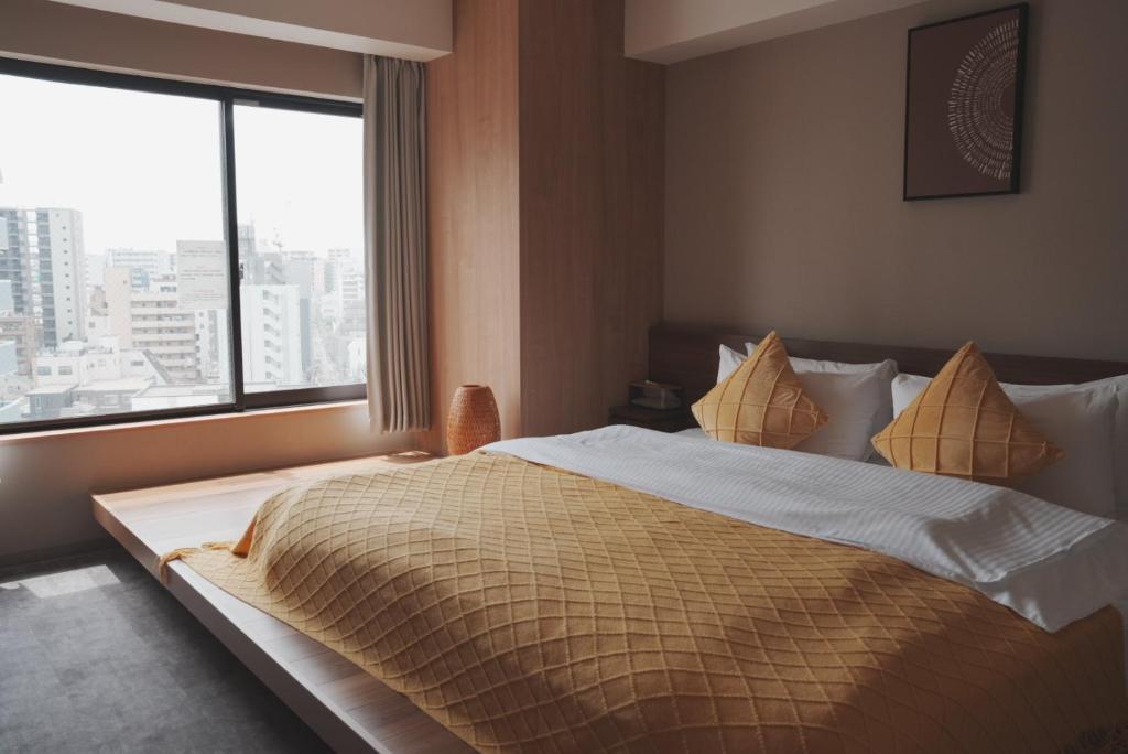 Postel nebo postele na pokoji v ubytování ICHIYU HOTEL ASAKUSA