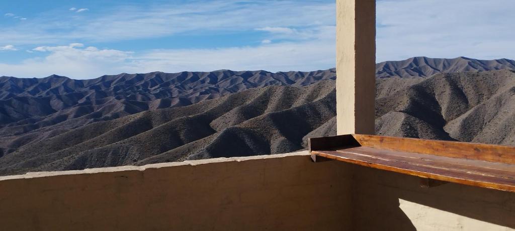 a bench sitting on top of a mountain view at La Nave 2 in Potrerillos