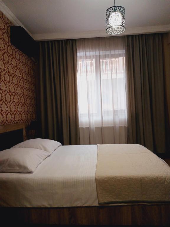 Postel nebo postele na pokoji v ubytování MANGO Guesthouse