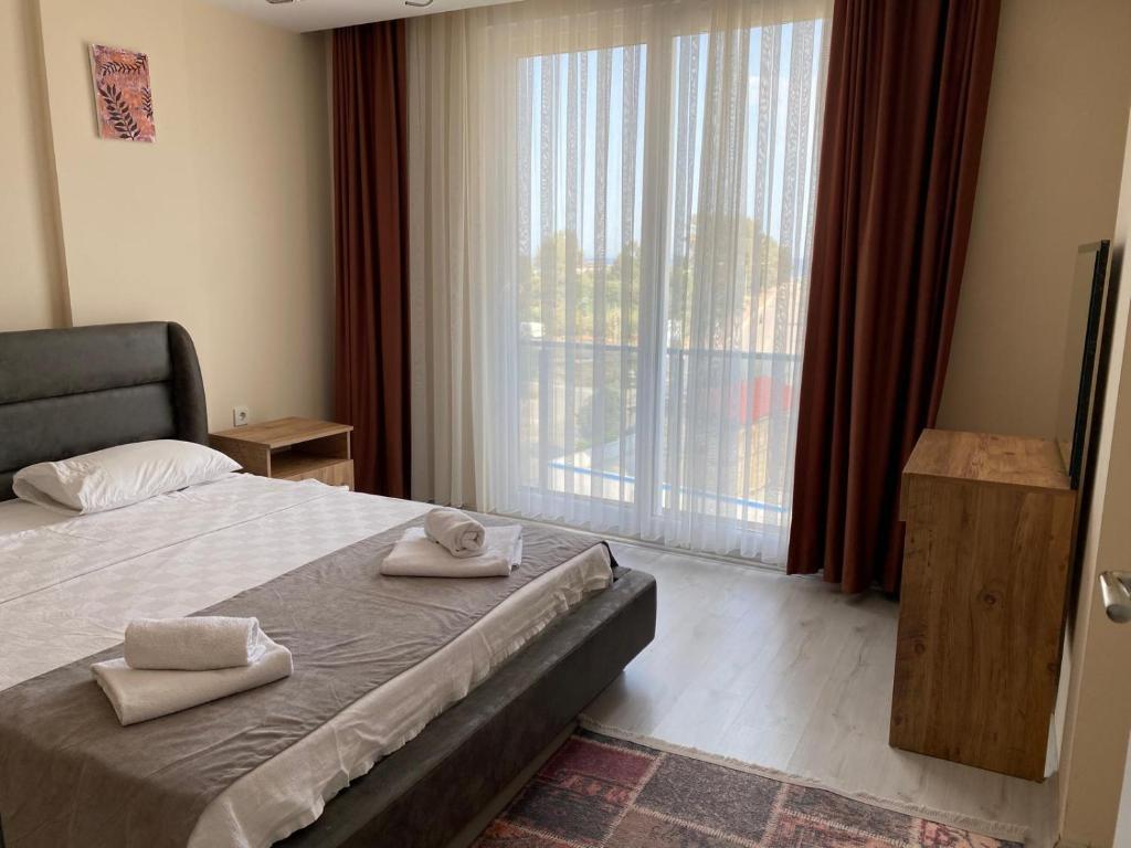 a bedroom with a bed and a large window at Atlas Apart Demre in Antalya