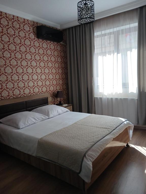 Postel nebo postele na pokoji v ubytování MANGO Guesthouse