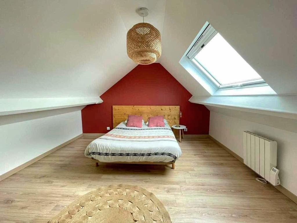 a bedroom with a bed in a attic with a window at Le Duplex Messin Calais Nord Plage - proche Ferry in Calais
