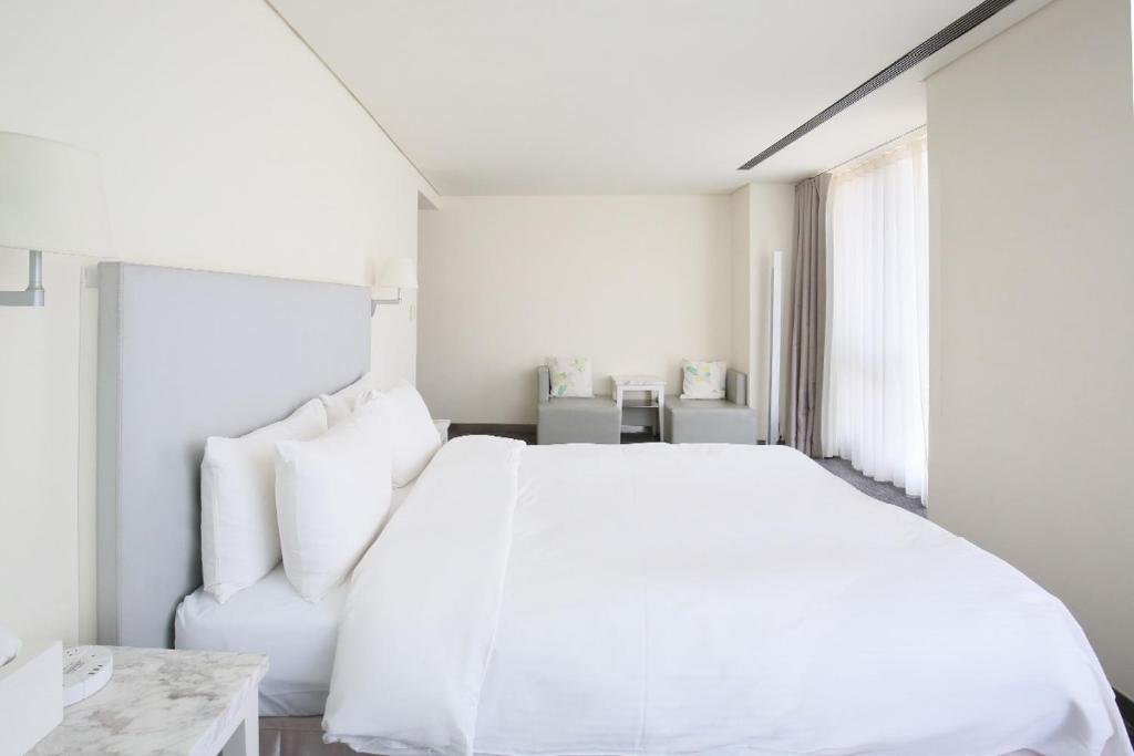Postel nebo postele na pokoji v ubytování Ambience Hotel Taipei