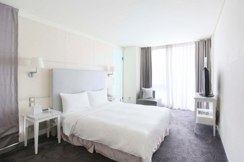Postel nebo postele na pokoji v ubytování Ambience Hotel Taipei