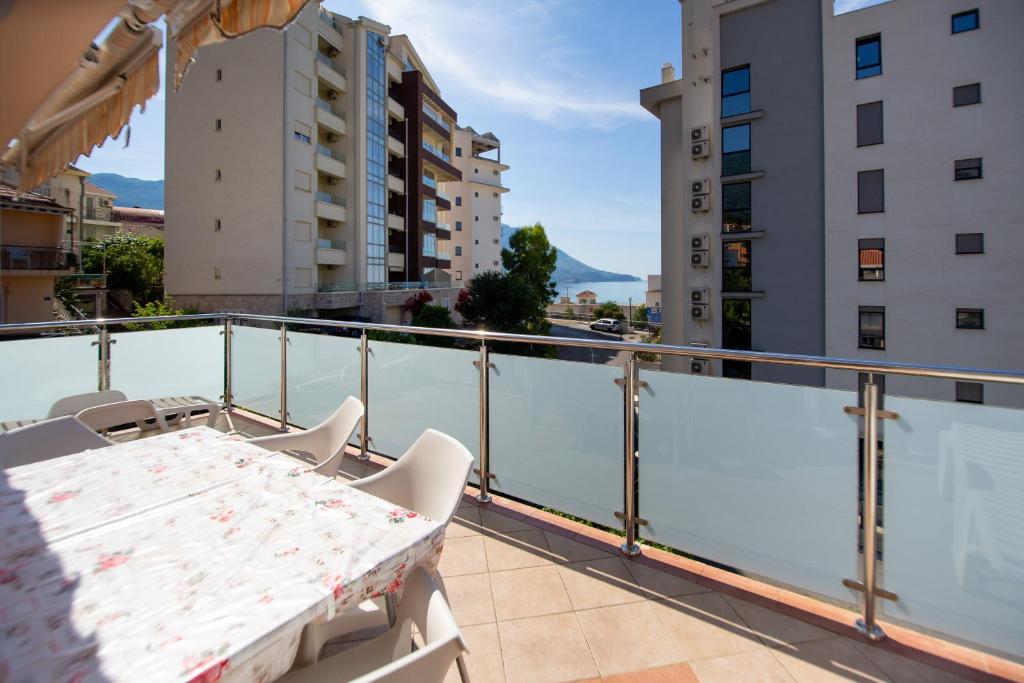 a balcony with a table and chairs and buildings at Apartmani Becici in Bečići