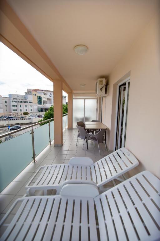 a balcony with a bed and a table at Apartmani Becici in Bečići
