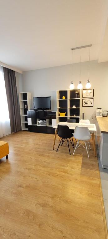 a living room with a white table and chairs at Apartament Magnolia in Nysa