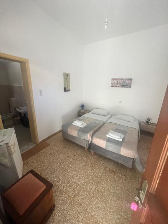 Postel nebo postele na pokoji v ubytování Hotel Glaros Lipsi