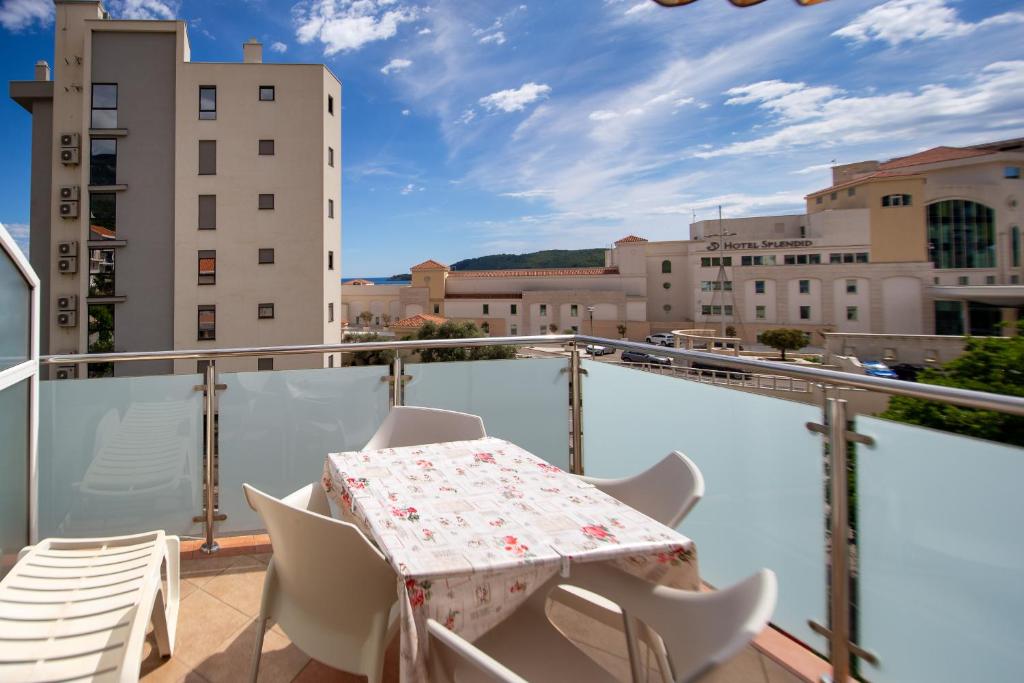 a balcony with a table and chairs on a roof at Apartmani Becici in Bečići