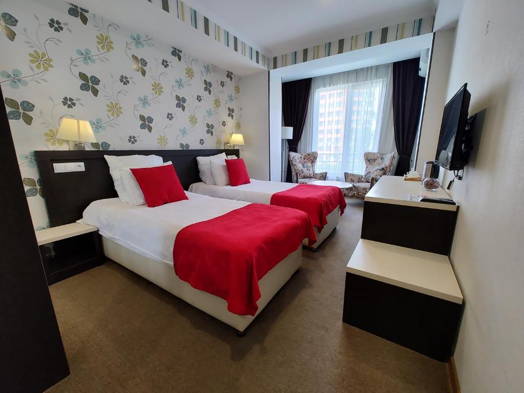 Postel nebo postele na pokoji v ubytování East Gate Boutique Hotel