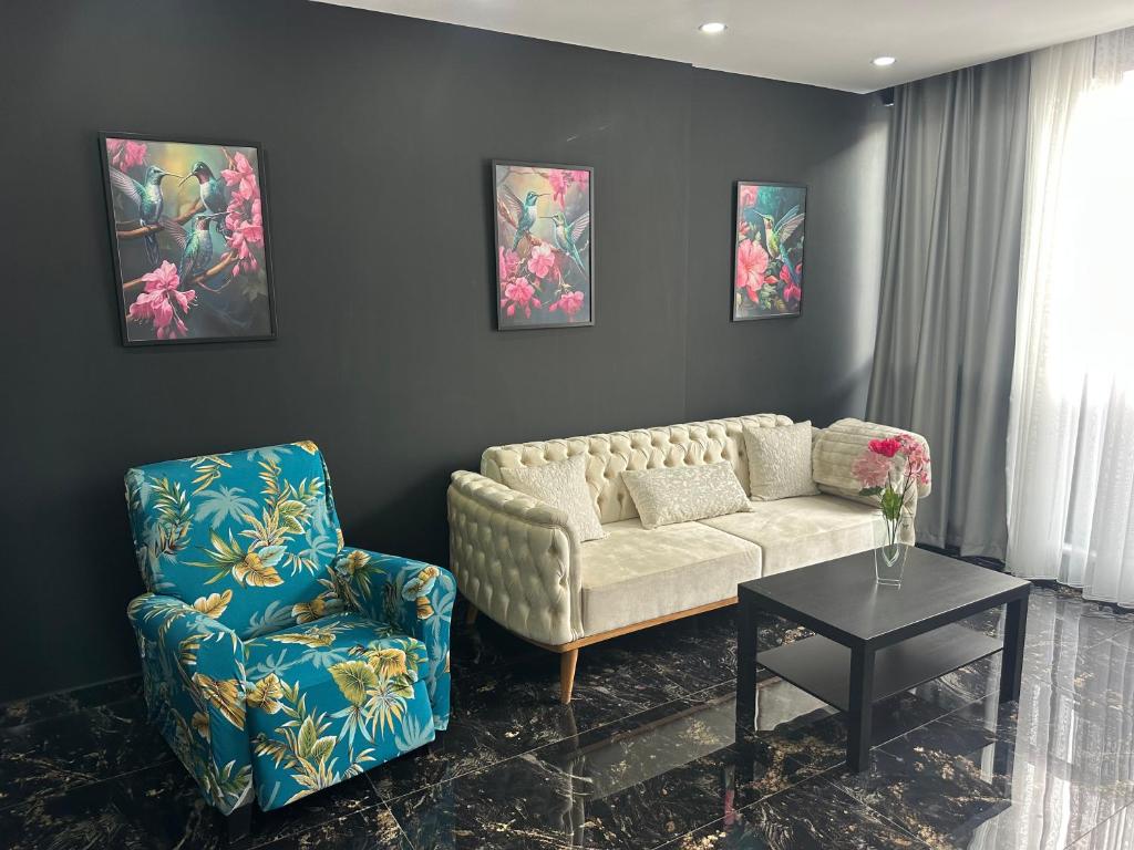 a living room with a couch and a chair at Belek Room Voyage in Belek