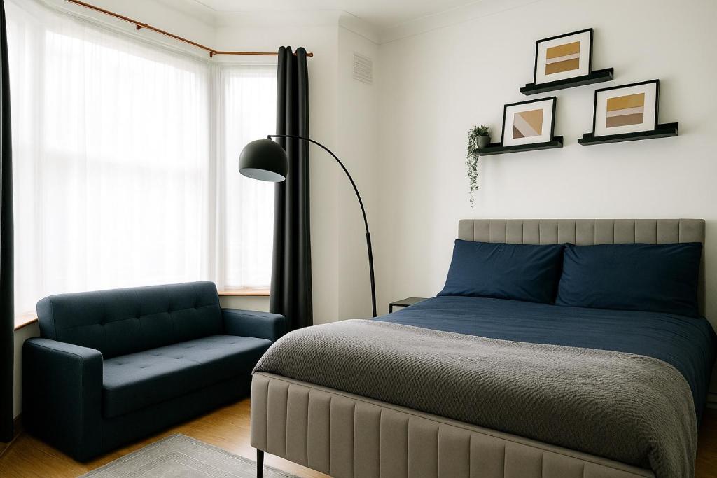 a bedroom with a bed and a chair at Entire 3 Bedroom Home With Garden In London in Edmonton