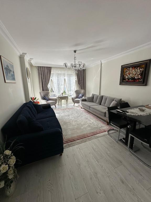 a living room with a couch and a piano at Konyaaltı gürsu denize sıfır sahilde full eşyalı lüks daire in Antalya