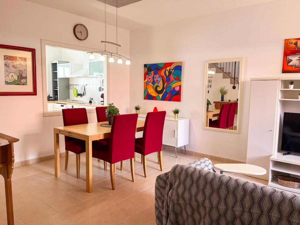 a dining room and living room with a table and chairs at Stunning Villa in Meloneras, Maspalomas in Maspalomas