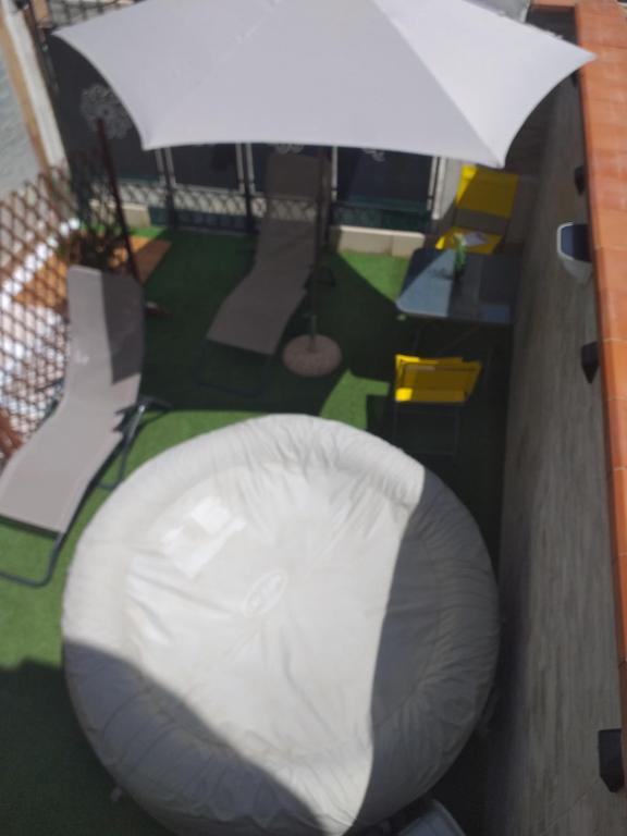 a white bean bag chair and an umbrella at Mazzeo in Santa Maria di Castellabate