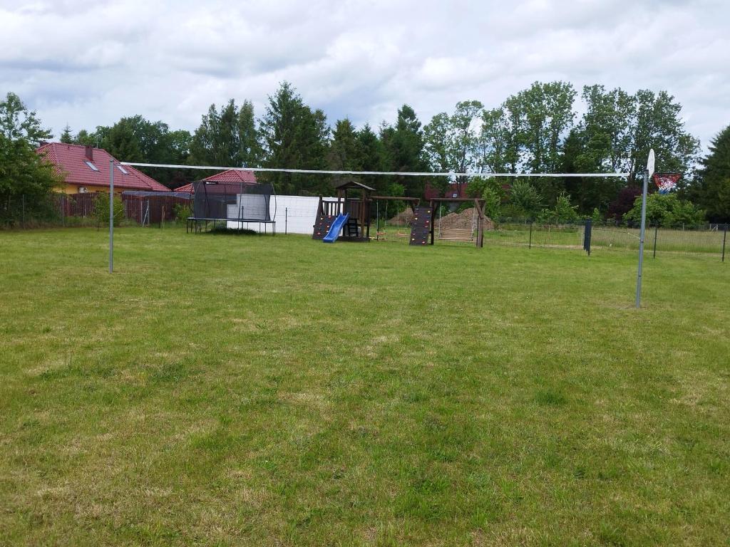 a large field with a volley ball hoop at Domki Pod Świerkami in Jezierzany