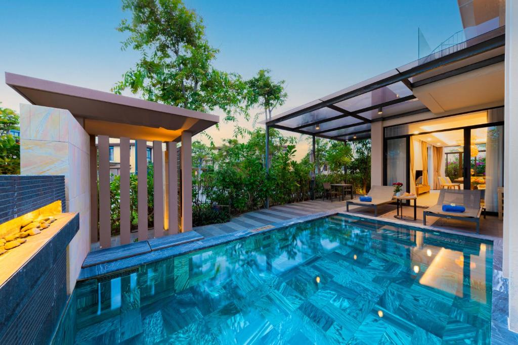 a swimming pool in the backyard of a house at Ocean sand villa in Cam Lâm