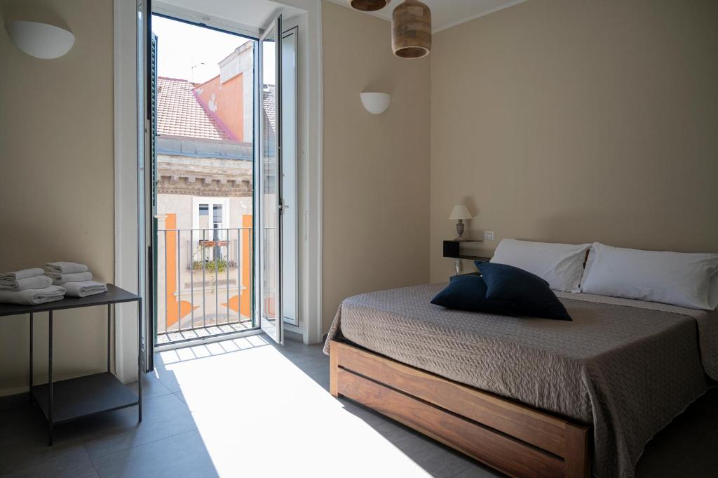 a bedroom with a bed and a sliding glass door at Bellavista Relais in Naples